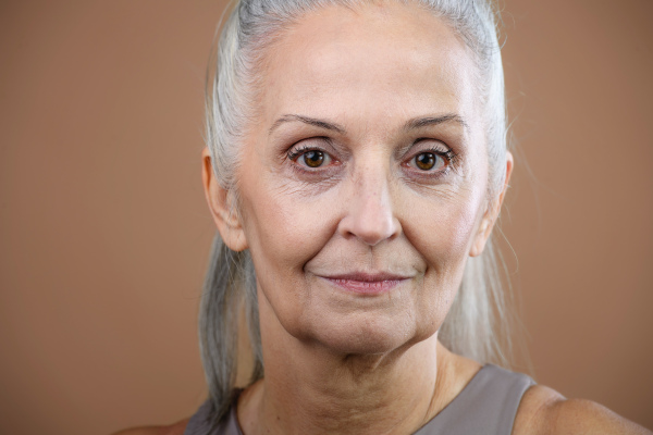 Portrait of serious senior woman in a studio.