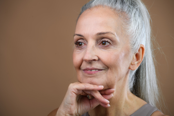 Portrait of smiling senior woman in a studio.