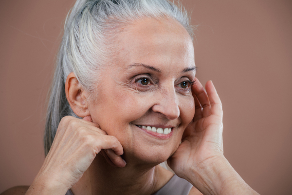 Portrait of smiling senior woman in a studio.