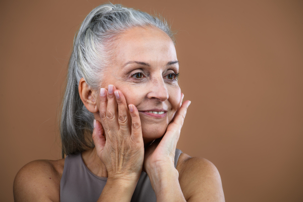 Portrait of smiling senior woman in a studio.