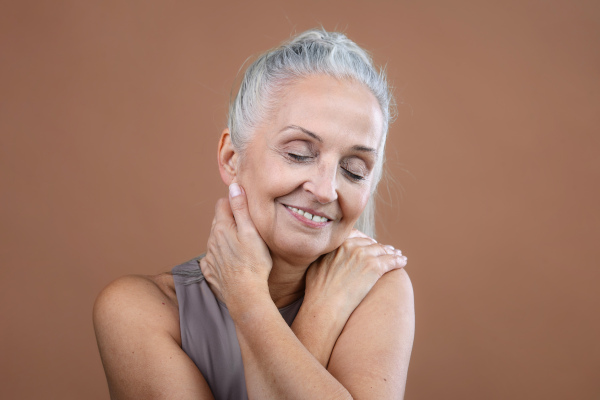 Portrait of smiling senior woman in a studio.