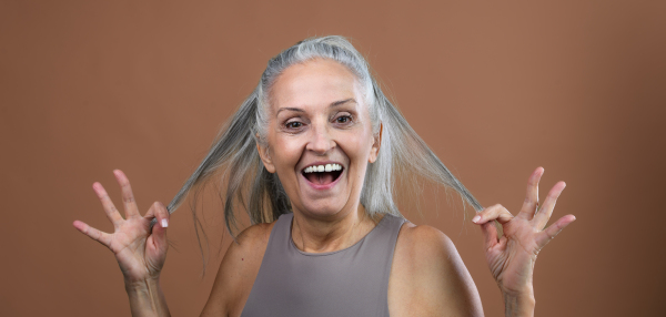 Portrait of smiling senior woman in a studio.