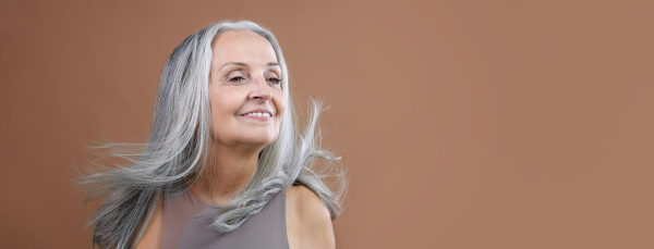 Portrait of smiling senior woman in a studio.