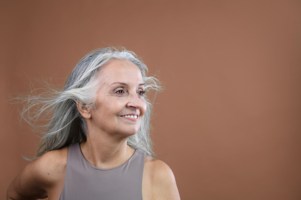 Portrait of smiling senior woman in a studio.