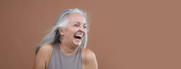 Portrait of smiling senior woman in a studio.