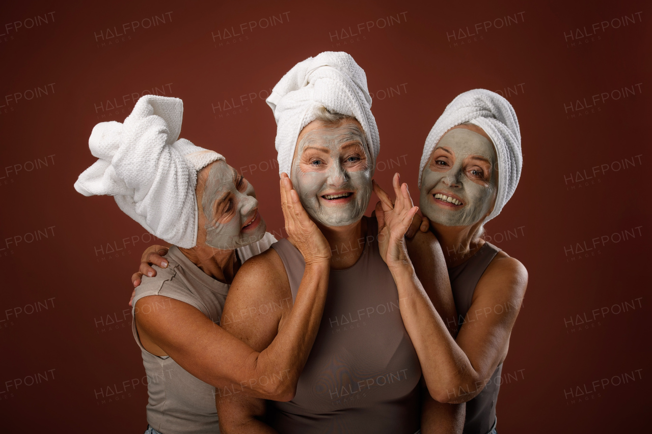 Portrait of happy senior friends with a face-mask, selfcare and skin routine concept.