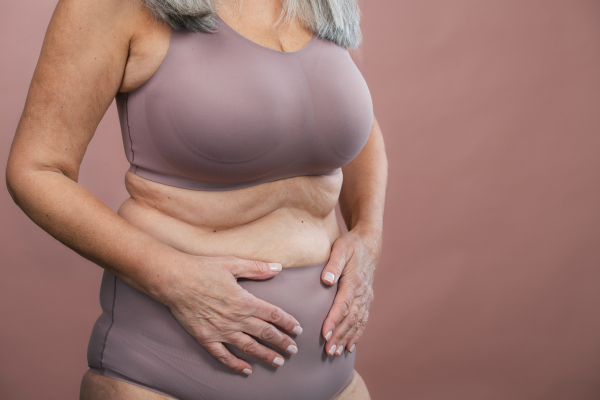 Close-up of a senior woman body, studio shoot.