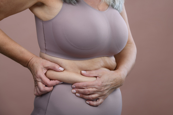 Close-up of a senior woman body, studio shoot.