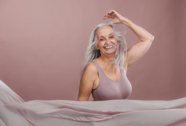 Portrait of happy senior woman in a studio.