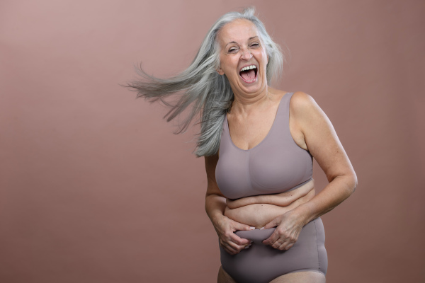 Portrait of senior woman in a lingerie, studio shoot.