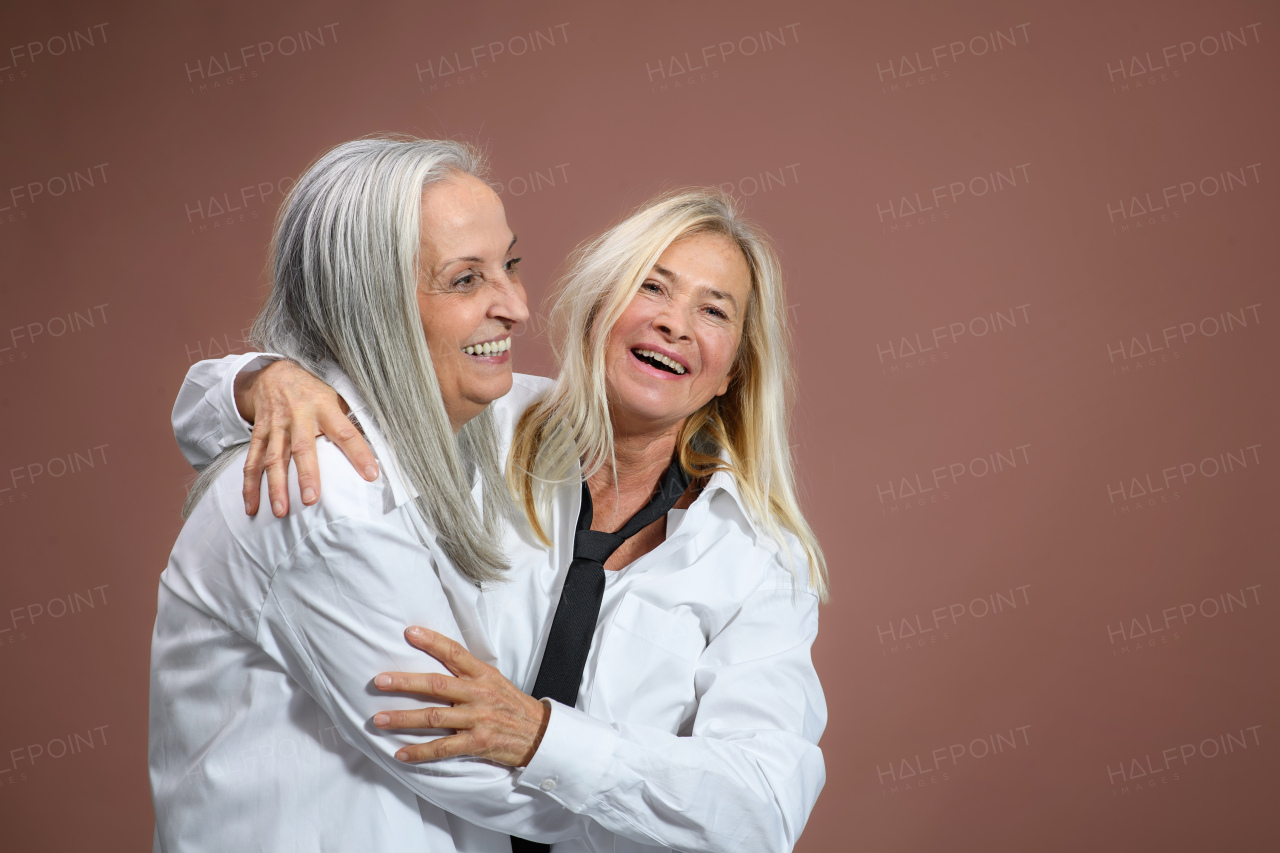 Portrait of happy senior friends in a studio.