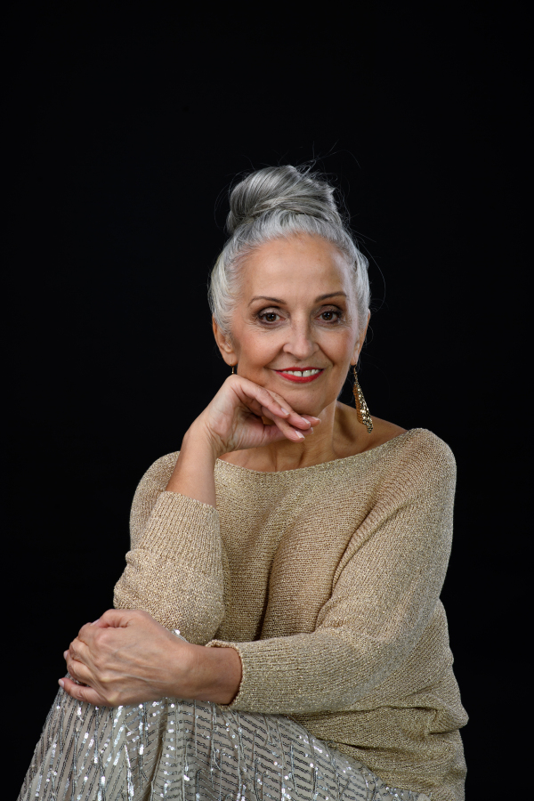 Portrait of well dressed senior woman in party outfit, celebration concept. Isolated on black background.