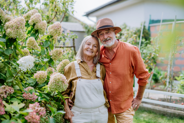 Senior couple in love posing together in a garden.