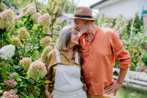 Senior couple in love posing together in a garden.