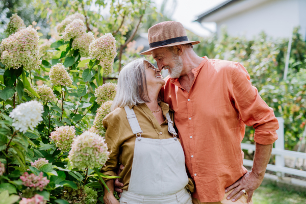 Senior couple in love posing together in a garden.