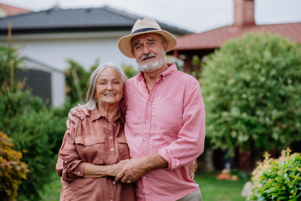 Senior couple in love posing together in a garden.