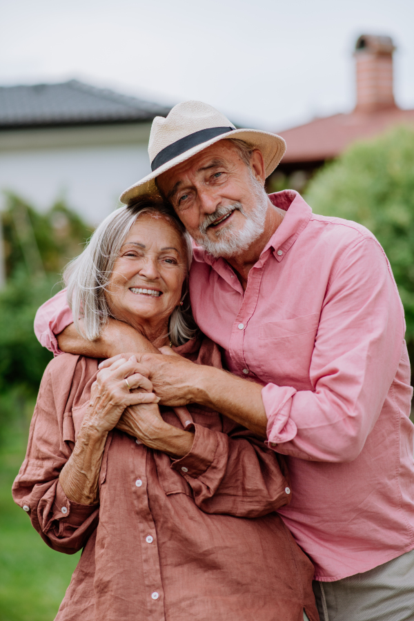 Senior couple in love posing together in a garden.