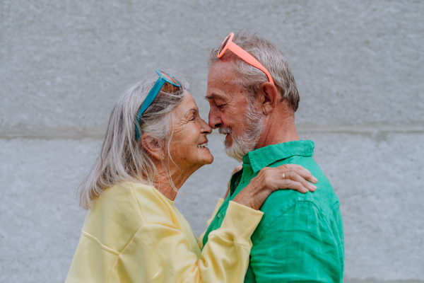 Portrait of senior couple in love in colourful clothes.