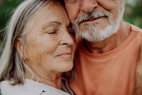 Portrait of senior couple in love, standing outdoor in the nature.