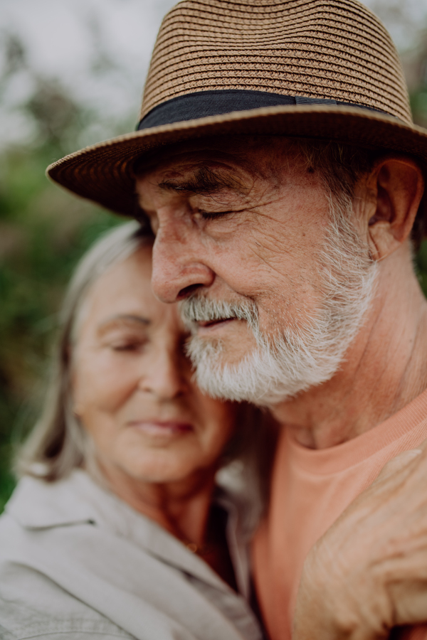 Portrait of senior couple in love, standing outdoor in the nature.