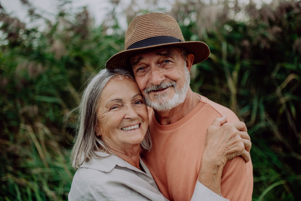 Portrait of senior couple in love, standing outdoor in the nature.