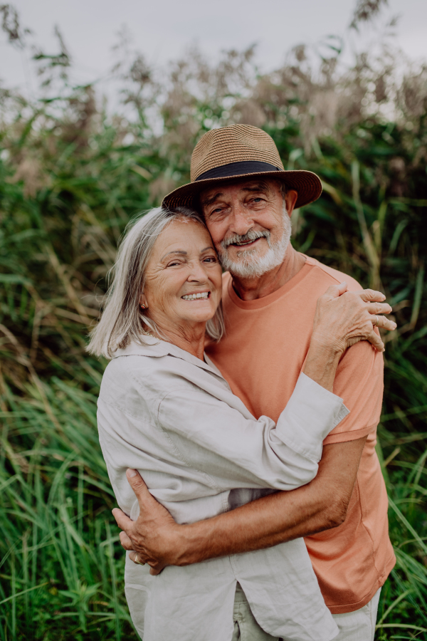 Portrait of senior couple in love, standing outdoor in the nature.