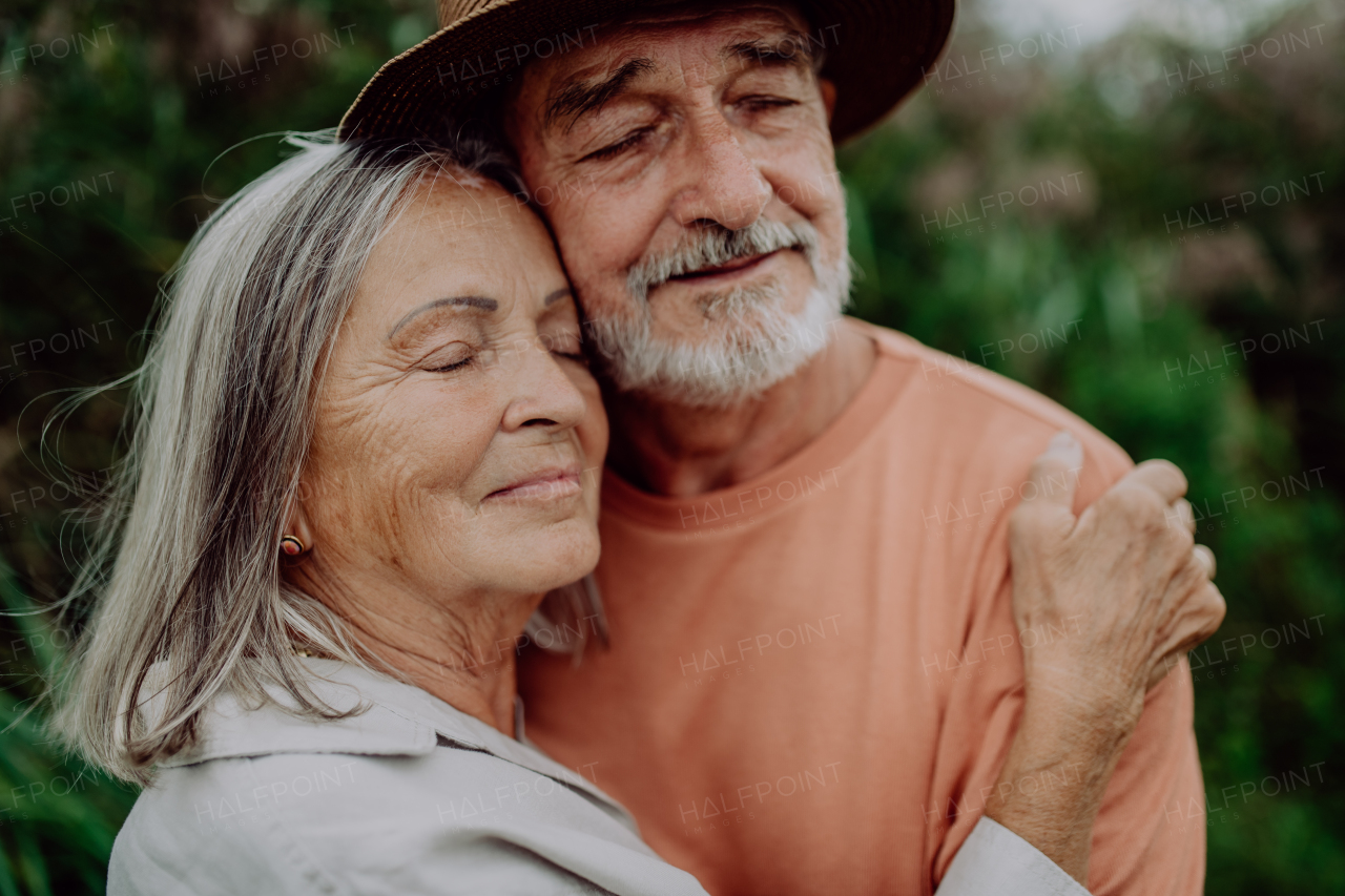 Portrait of senior couple in love, standing outdoor in the nature.