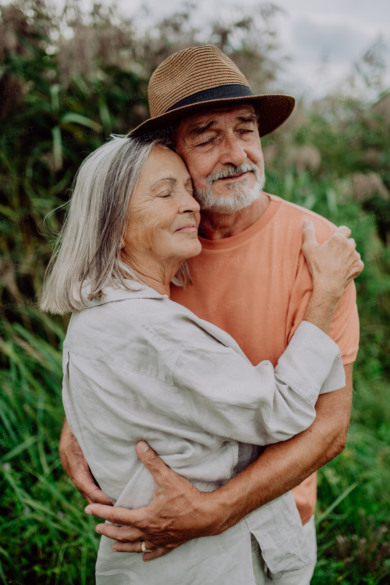 Portrait of senior couple in love, standing outdoor in the nature.