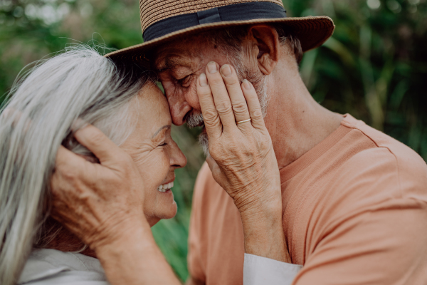 Portrait of senior couple in love, standing outdoor in the nature.