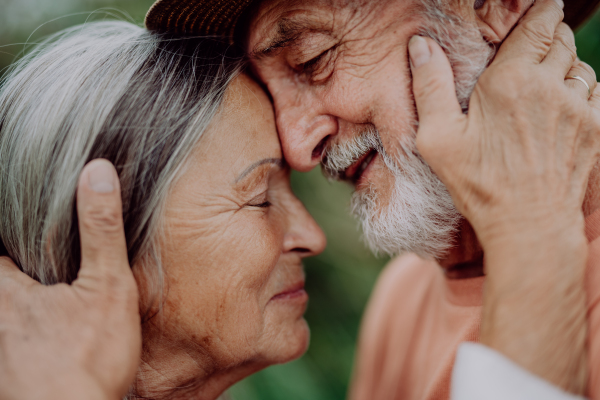 Portrait of senior couple in love, standing outdoor in the nature.