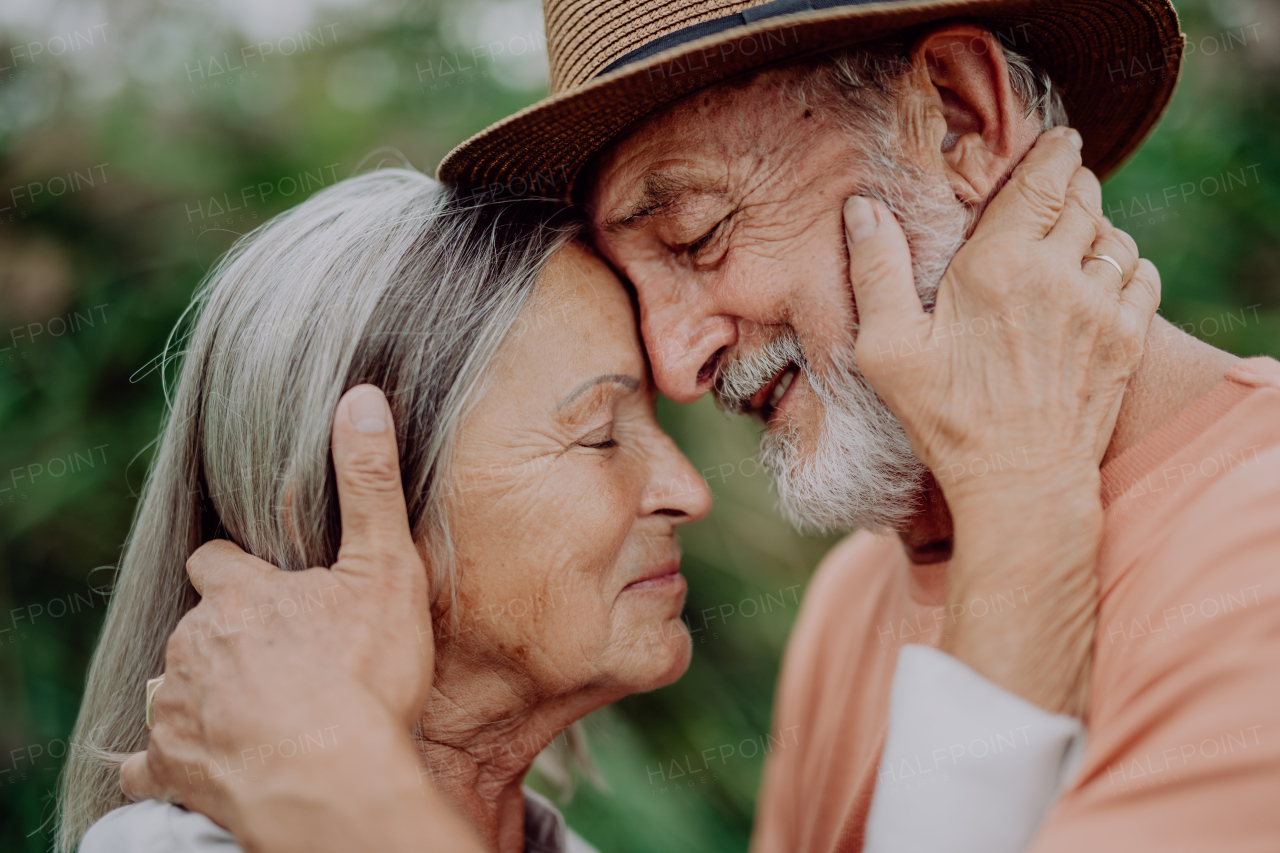 Portrait of senior couple in love, standing outdoor in the nature.