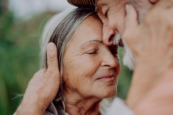 Portrait of senior couple in love, standing outdoor in the nature.