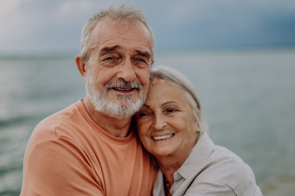 Portrait of senior couple in love, standing and hugging outdoor in the nature.