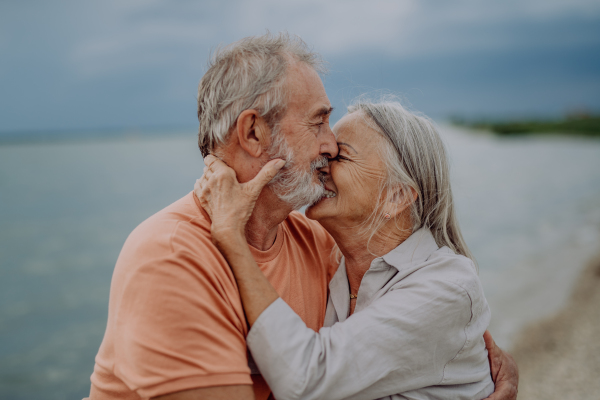 Portrait of senior couple in love, standing and hugging outdoor in the nature.