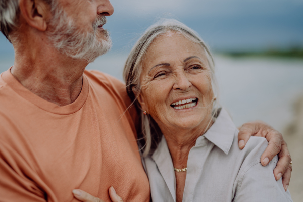 Senior couple relaxing and having romantic moment at the autumn sea.