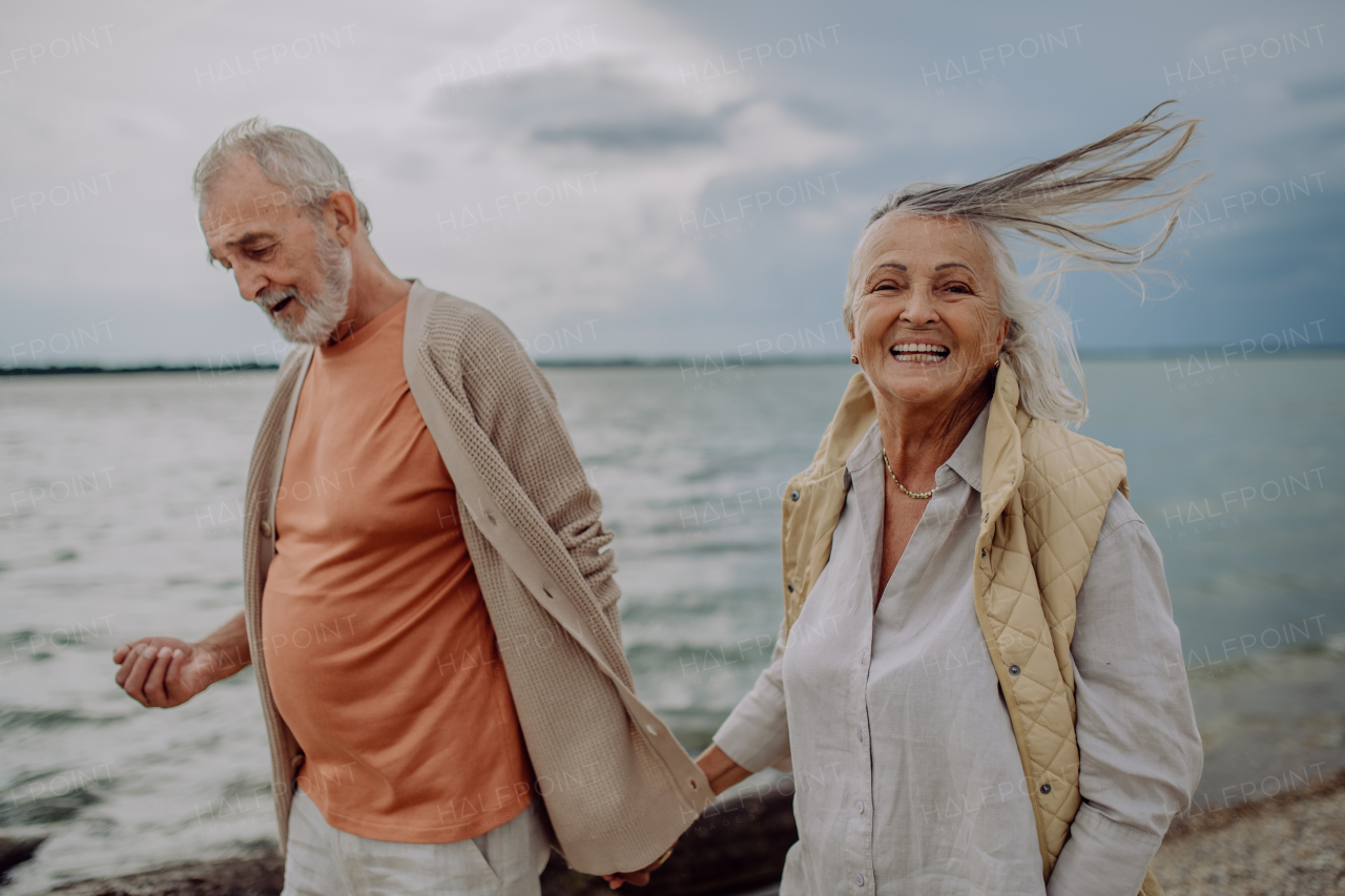 Senior couple relaxing and having romantic moment at the autumn sea.