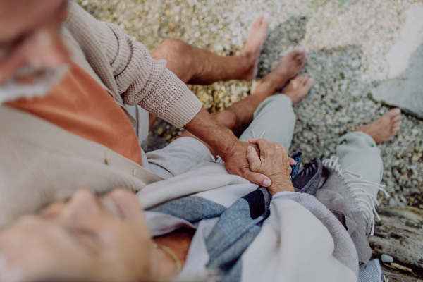 Senior couple relaxing and having romantic moment at the autumn sea.