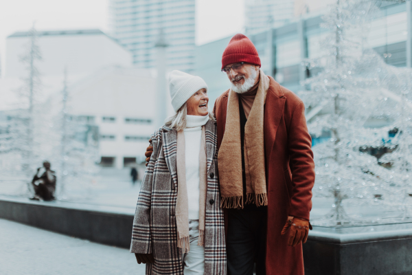 Senior couple walking in a winter city center.