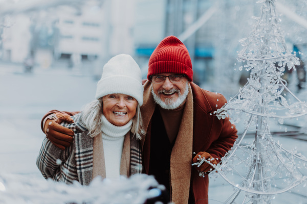 Senior couple walking in a winter city center.