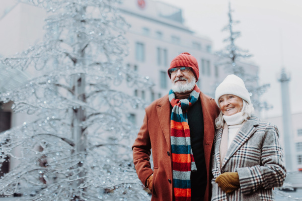 Senior couple walking in a winter city center.