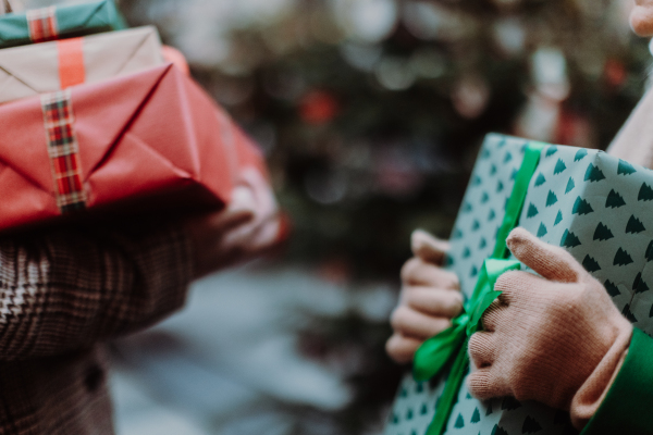 Close up of lot of Chrismtas gifts in hands. Christmas shopping spree.