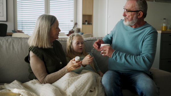 Grandparents taking care of their sick little granddaughter.