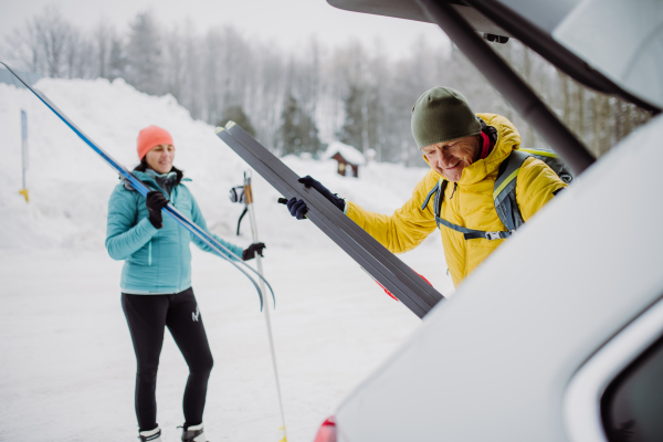 Happy senior woman preparing for skiing with her husband.