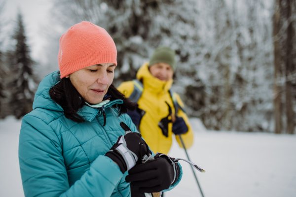 Senior couple having a break during cross country skiing.