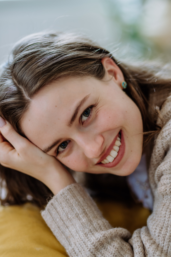 Portrait of young smiling woman in the apartment.