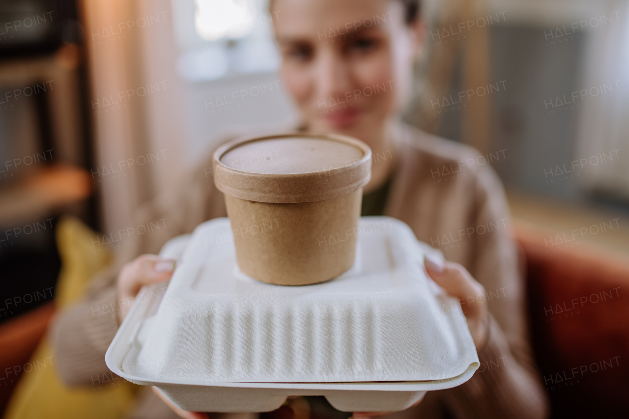 Young woman with ordered lunch from a restaurant.