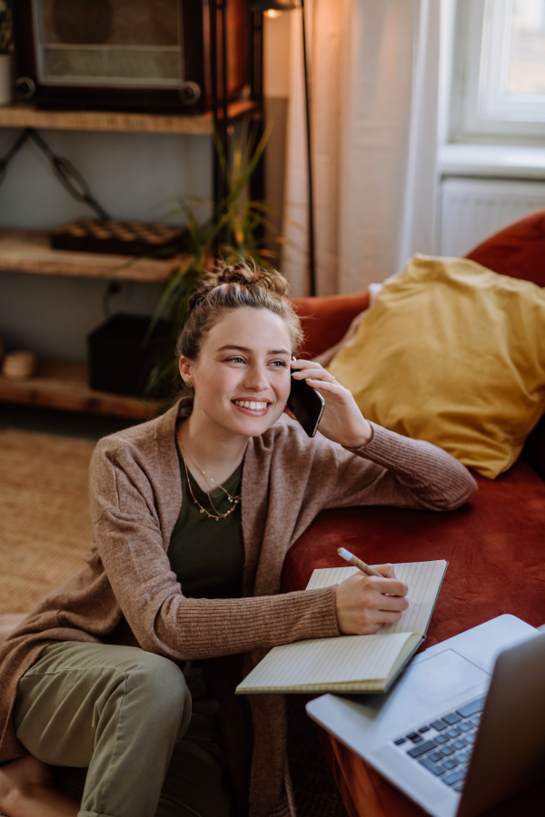 Young woman having home office in the apartment.