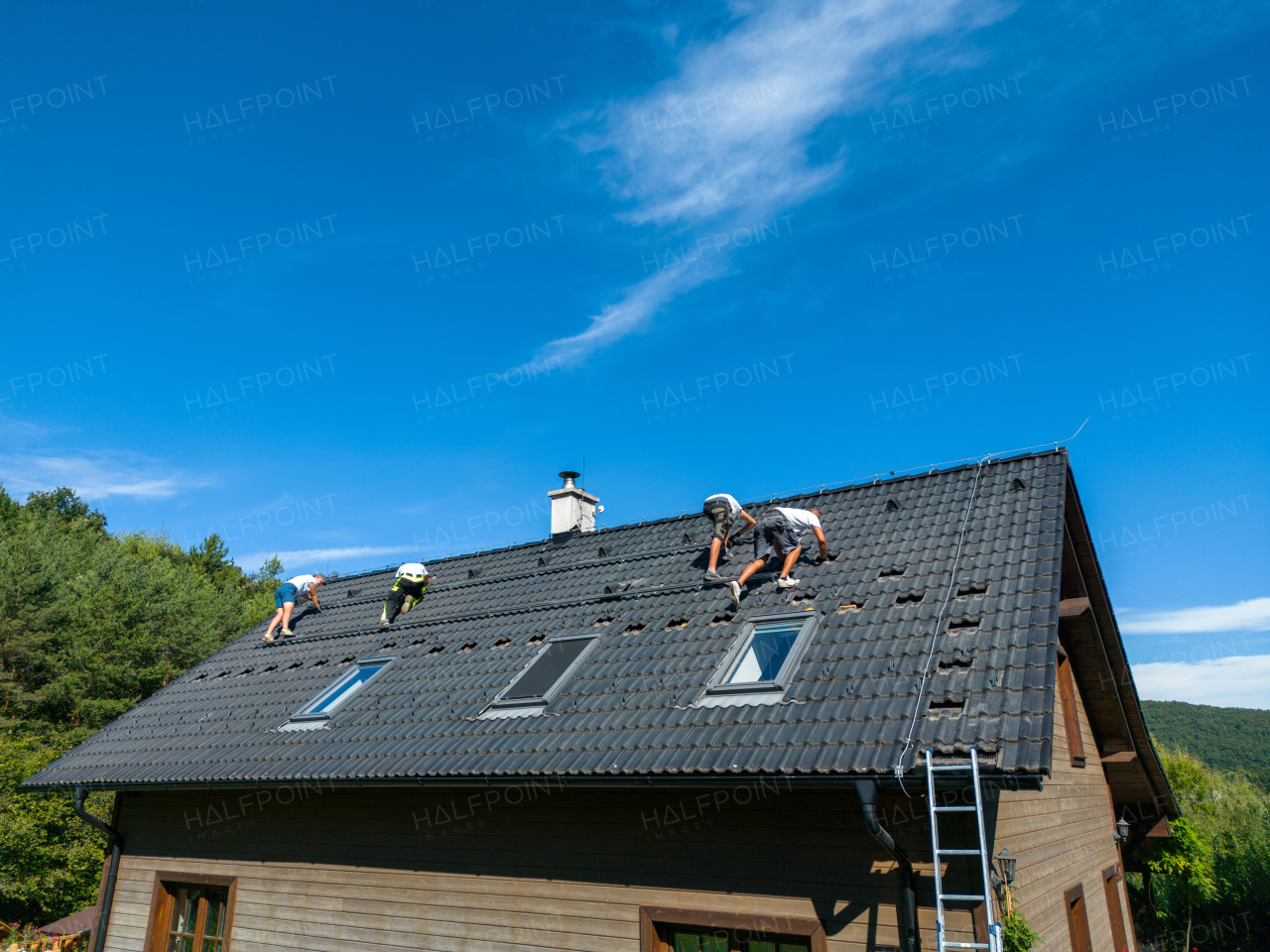 Men worker installing solar photovoltaic panels on a roof, alternative energy, saving resources and sustainable lifestyle concept.