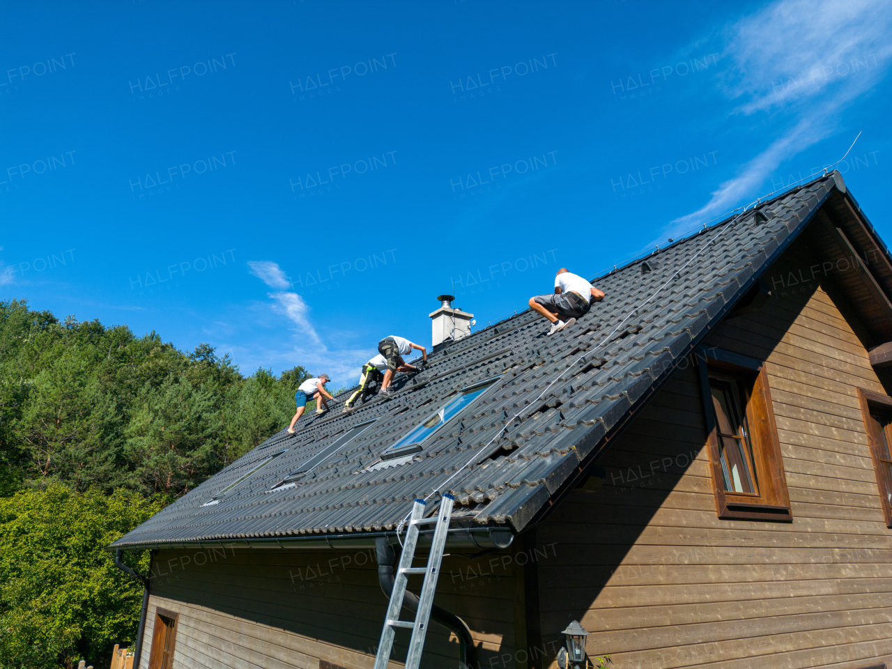 Men worker installing solar photovoltaic panels on a roof, alternative energy, saving resources and sustainable lifestyle concept.