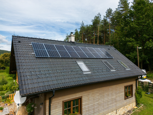 High angle view of solar photovoltaic panels on a roof, alternative energy, saving resources and sustainable lifestyle concept.